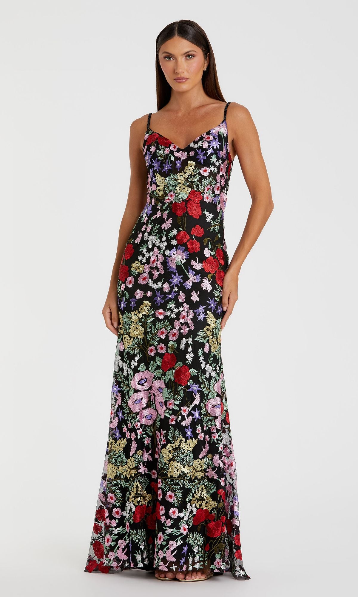 Woman modeling the Mac Duggal 67473 long black formal dress with a colorful floral print, standing against a plain white background.